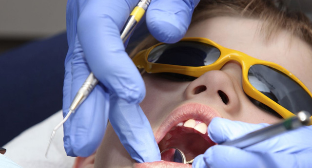 Little boy teeth under examination