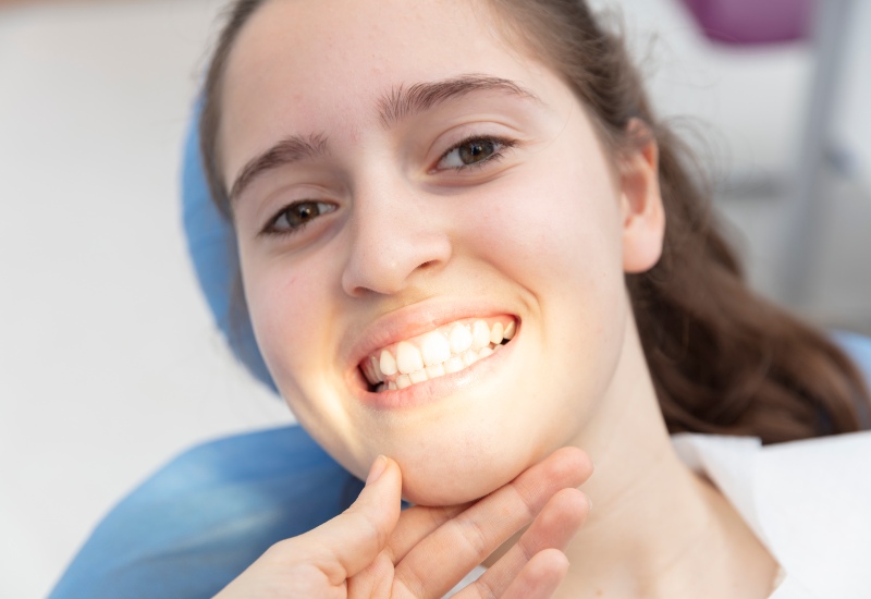 Patient is happy after the removal of dental braces in Arlington Heights, IL