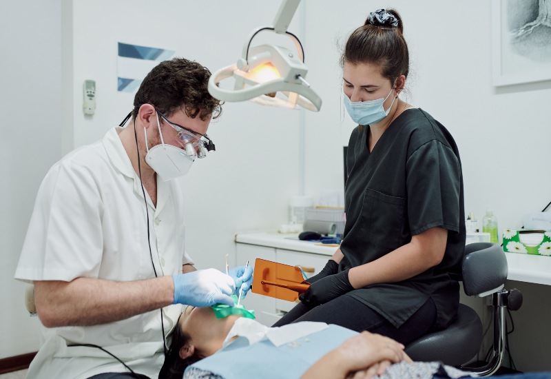 Dentist and assistant treating root canal in Antioch, IL