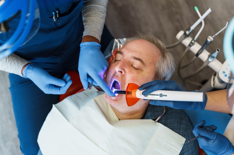 A dental professional applying dental sealants during treatment in Arlington Heights, IL