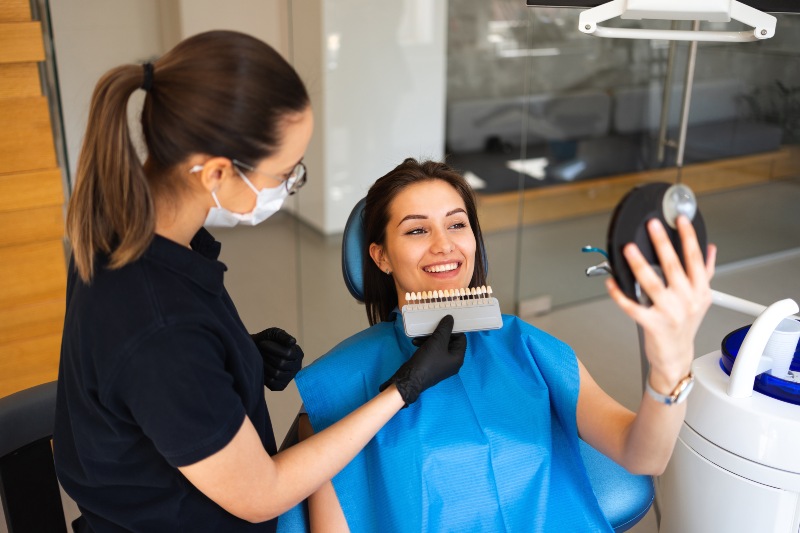 Tooth enamel shade matching during cosmetic dental consultation in Arlington Heights, IL
