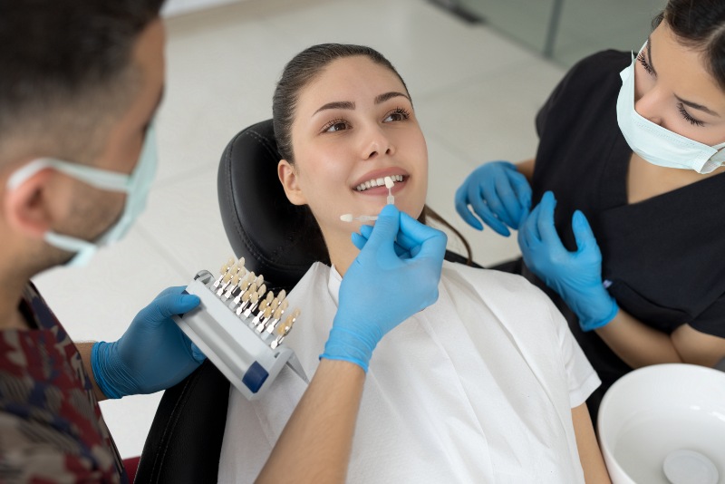 Dentist providing oral care guidance after veneers during a clinic visit in Arlington Heights, IL